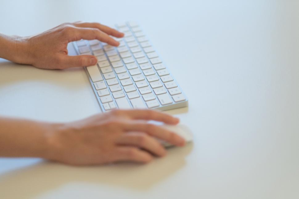 Free Image of Close-up of hands on a computer keyboard 