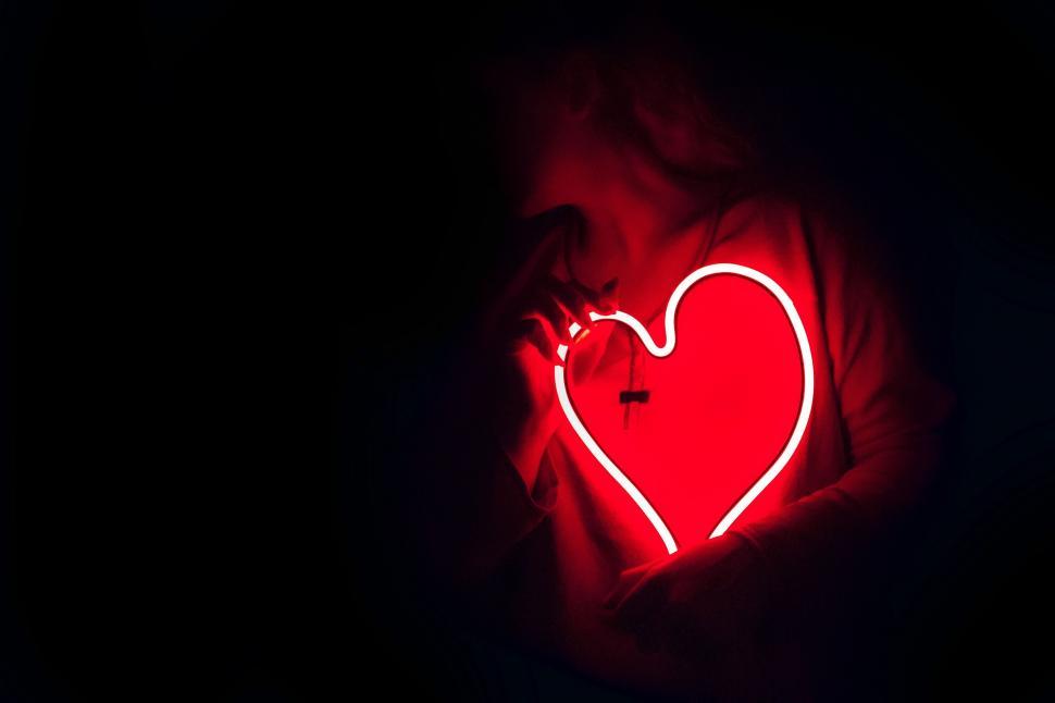 Free Image of Silhouette outline of heart glowing in darkness 