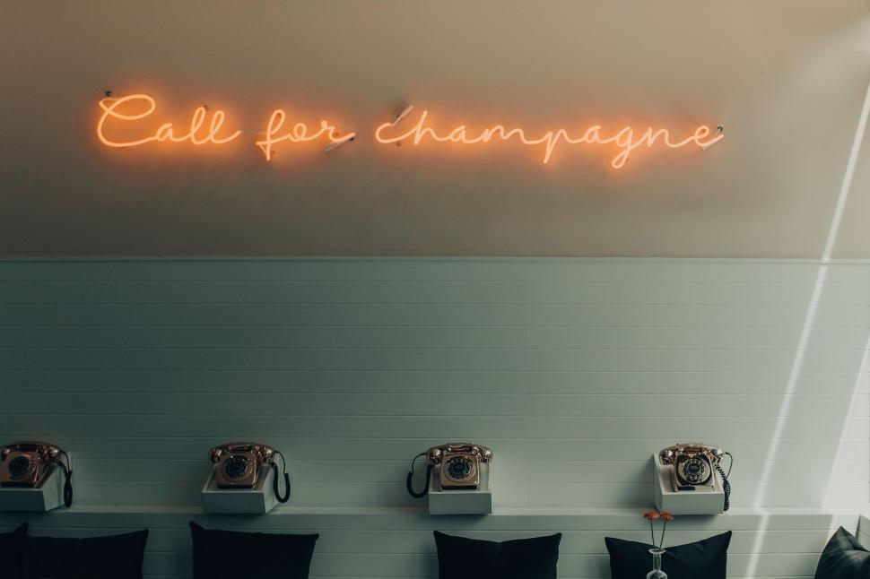 Free Image of Neon sign  Call for champagne  on minimalist backdrop 