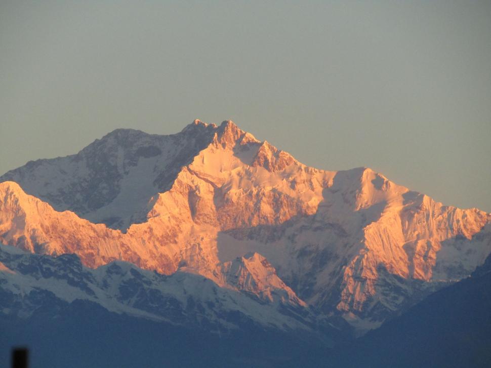 Free Image of Snow-covered mountain peak at sunrise 