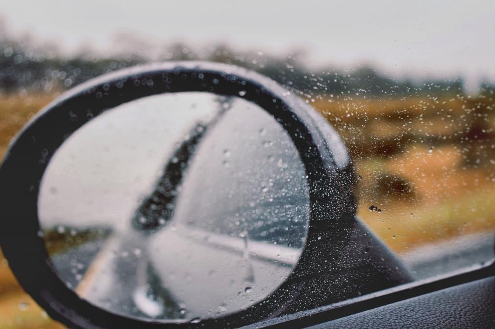 Free Image of Raindrops on car side mirror close-up 