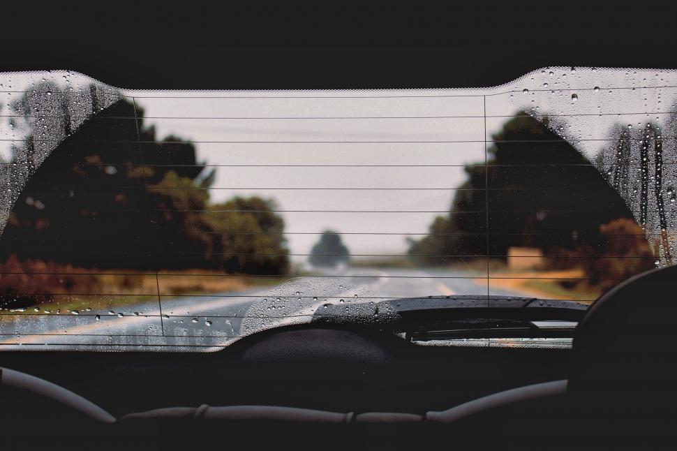 Free Image of Rain-covered car windshield driving view 