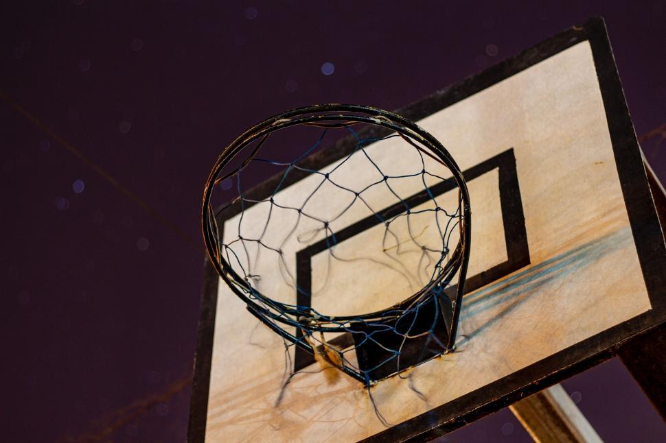 Free Image of Old basketball hoop with worn net 