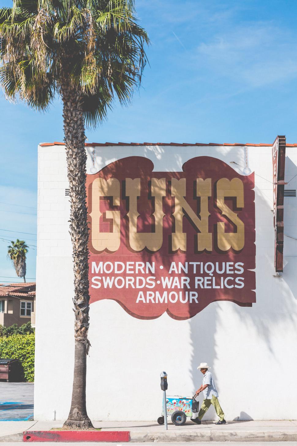 Free Image of Urban mural advertising guns and armor 