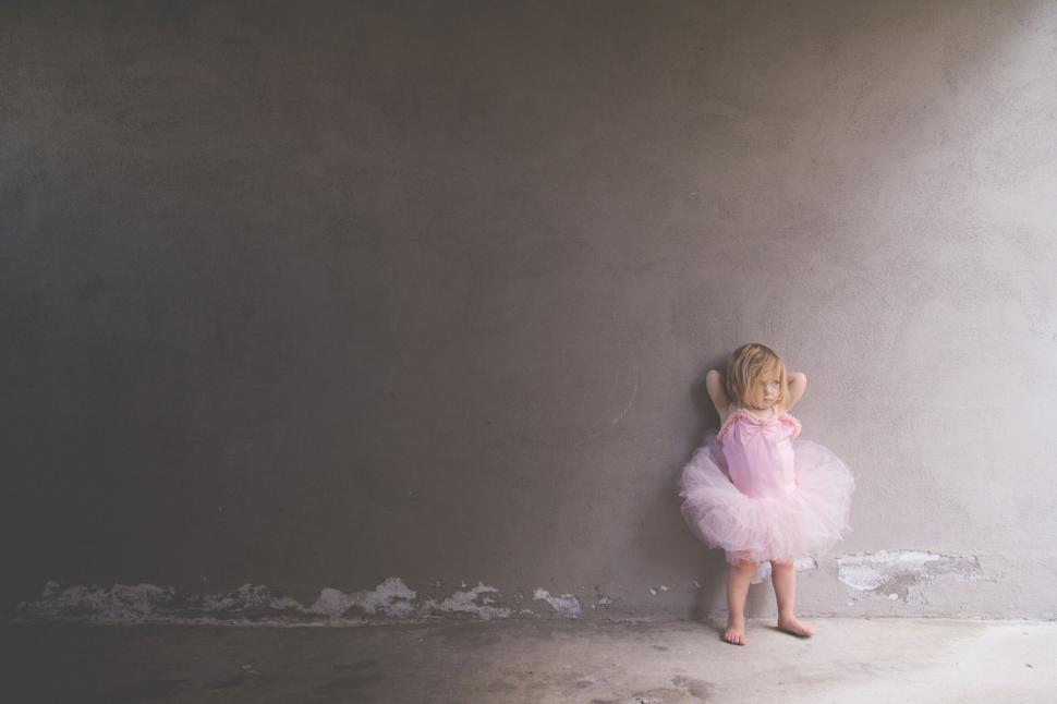 Free Image of Child in pink tutu facing wall 