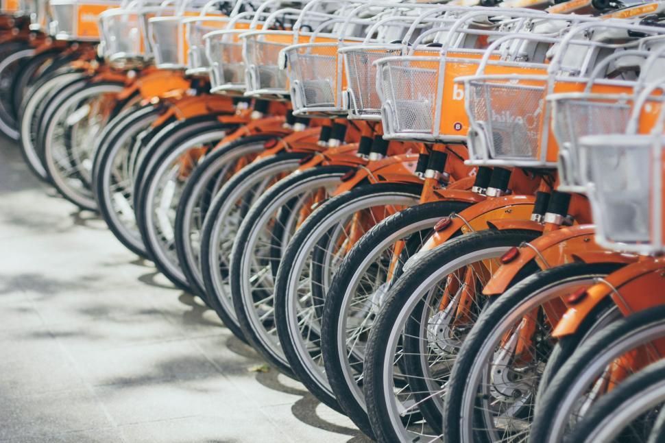 Free Image of Row of vibrant orange rental bikes 