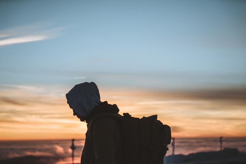 Free Image of Silhouetted traveler at sunrise horizon 