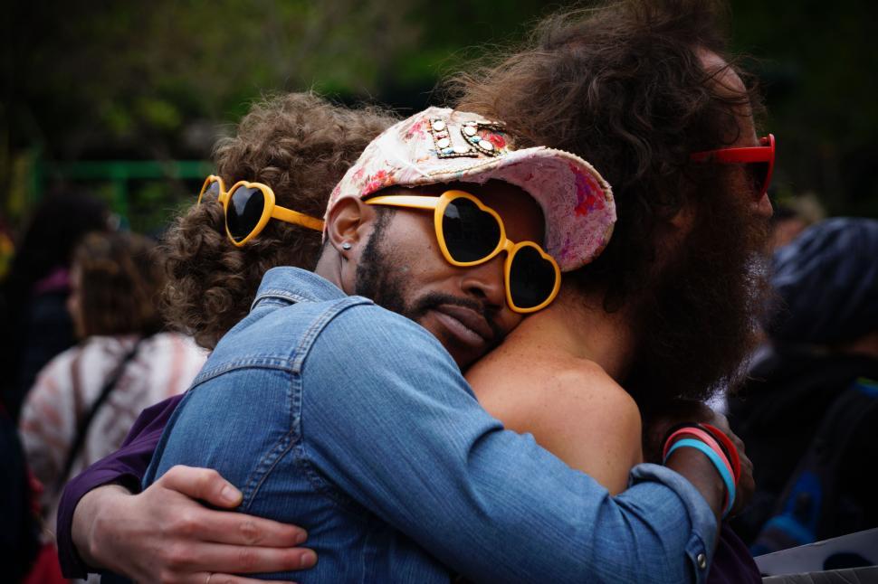 Free Image of Embracing couple at colorful gathering 