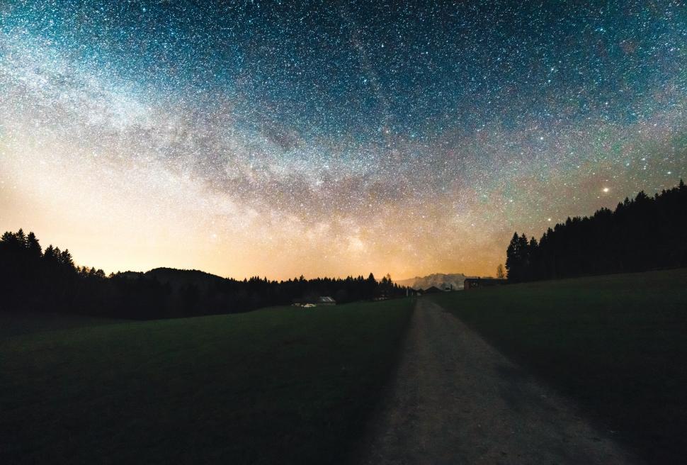 Free Image of Starry sky over a night landscape with pathway 