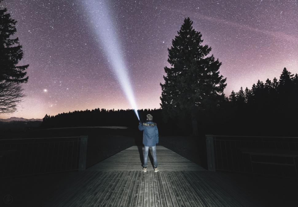 Free Image of Person with flashlight under starry sky 