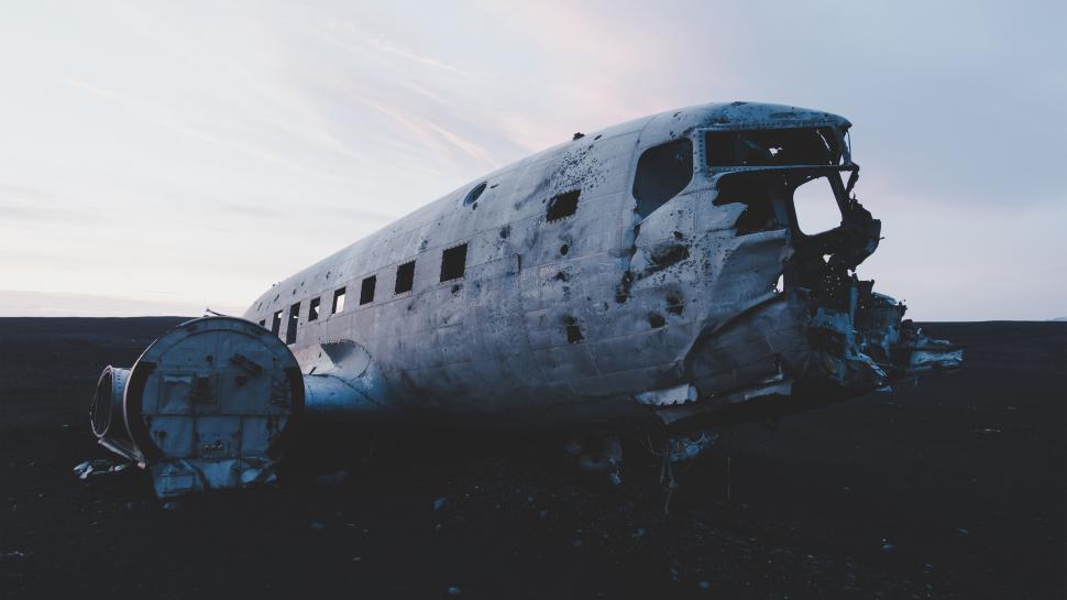Free Image of Abandoned aircraft wreckage in desolate landscape 