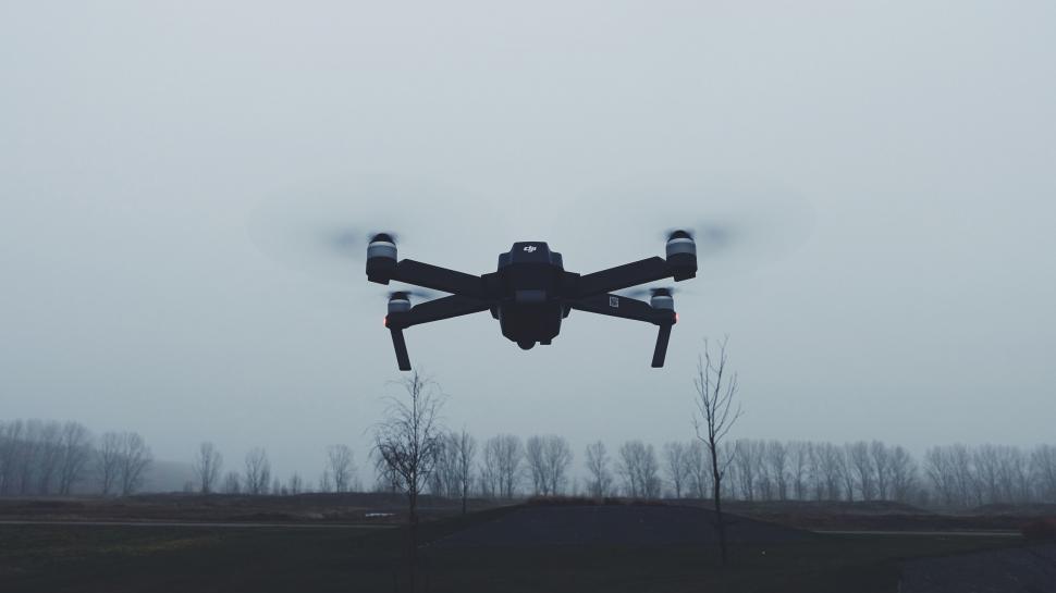 Free Image of Drone flying in a foggy overcast sky 