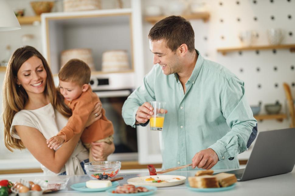 Free Image of Family enjoying breakfast and interacting in kitchen 
