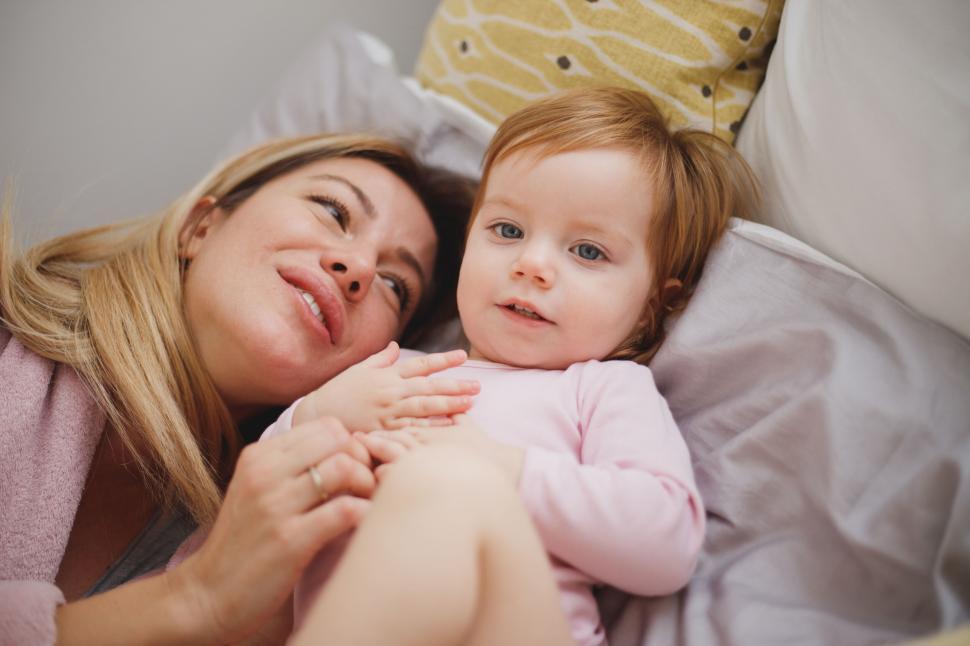 Free Image of Mother and daughter sharing a moment in bed 