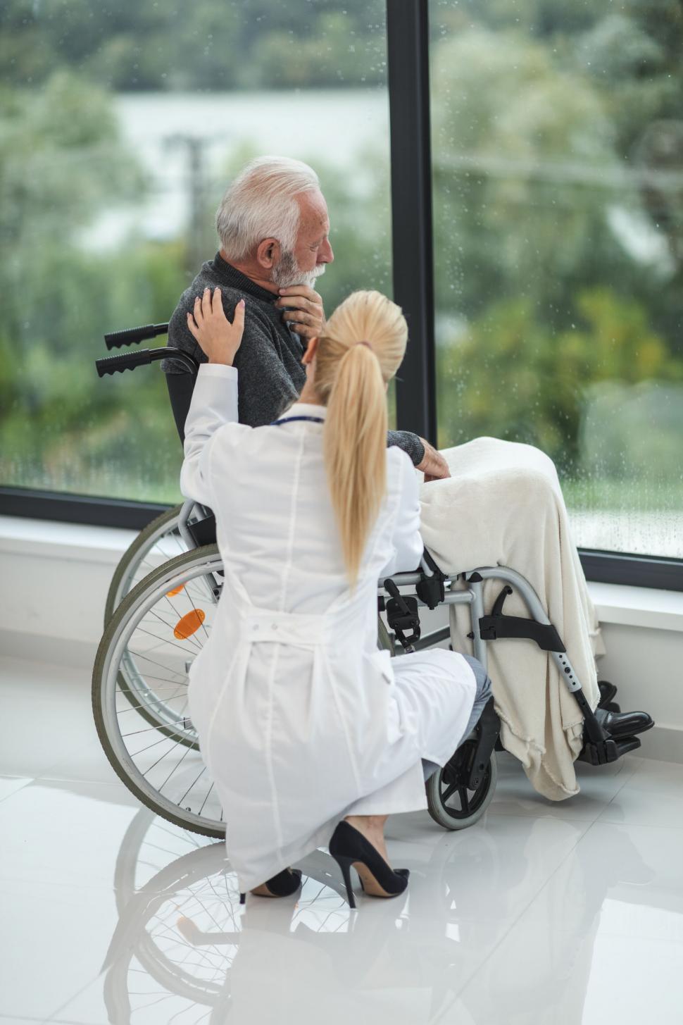 Free Image of Elder man with nurse in a wheelchair 