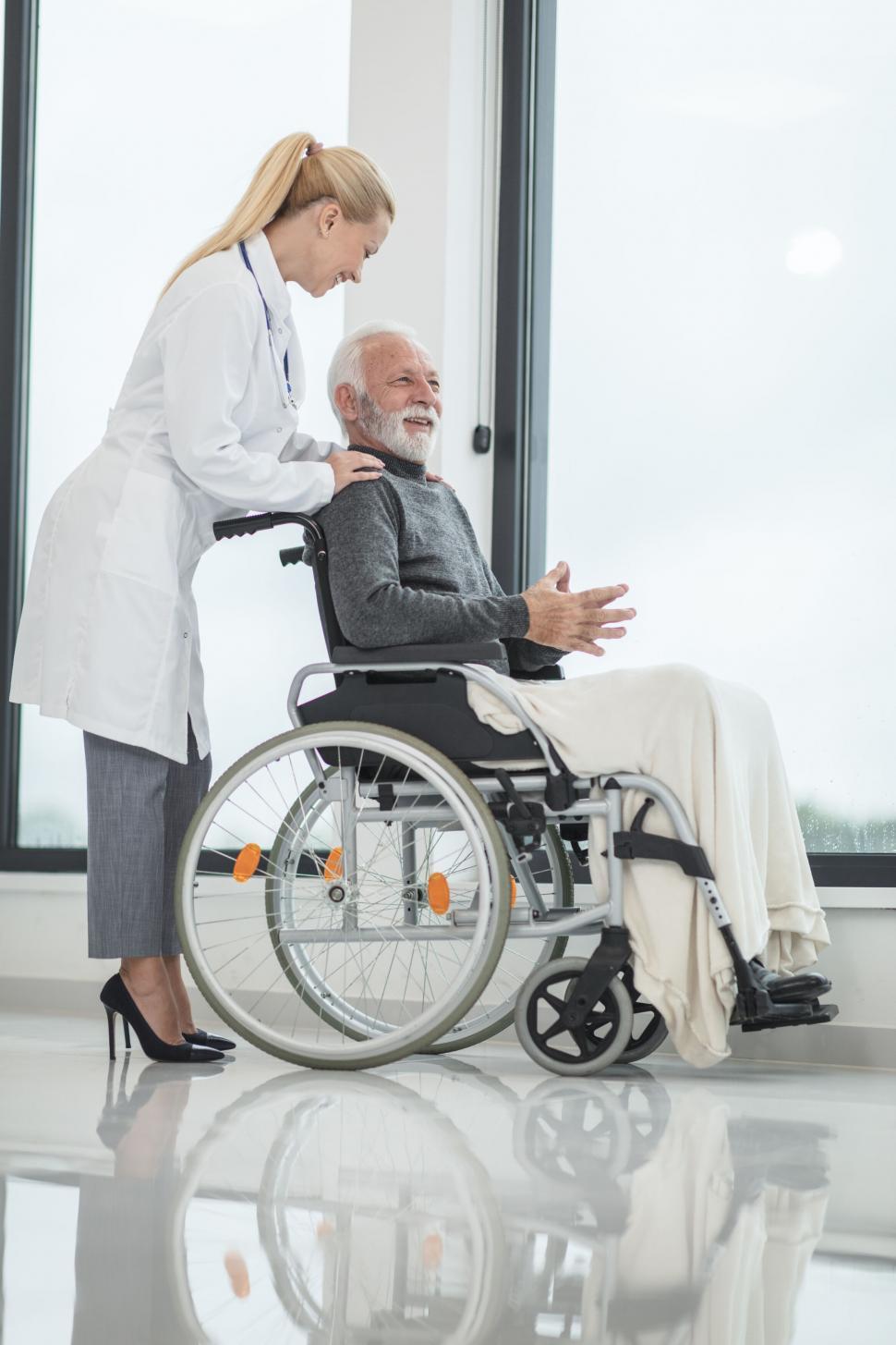 Free Image of Caring nurse comforting a senior patient 