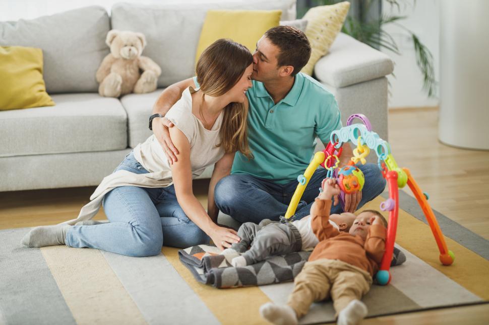 Free Image of Young family playing with a toddler at home 