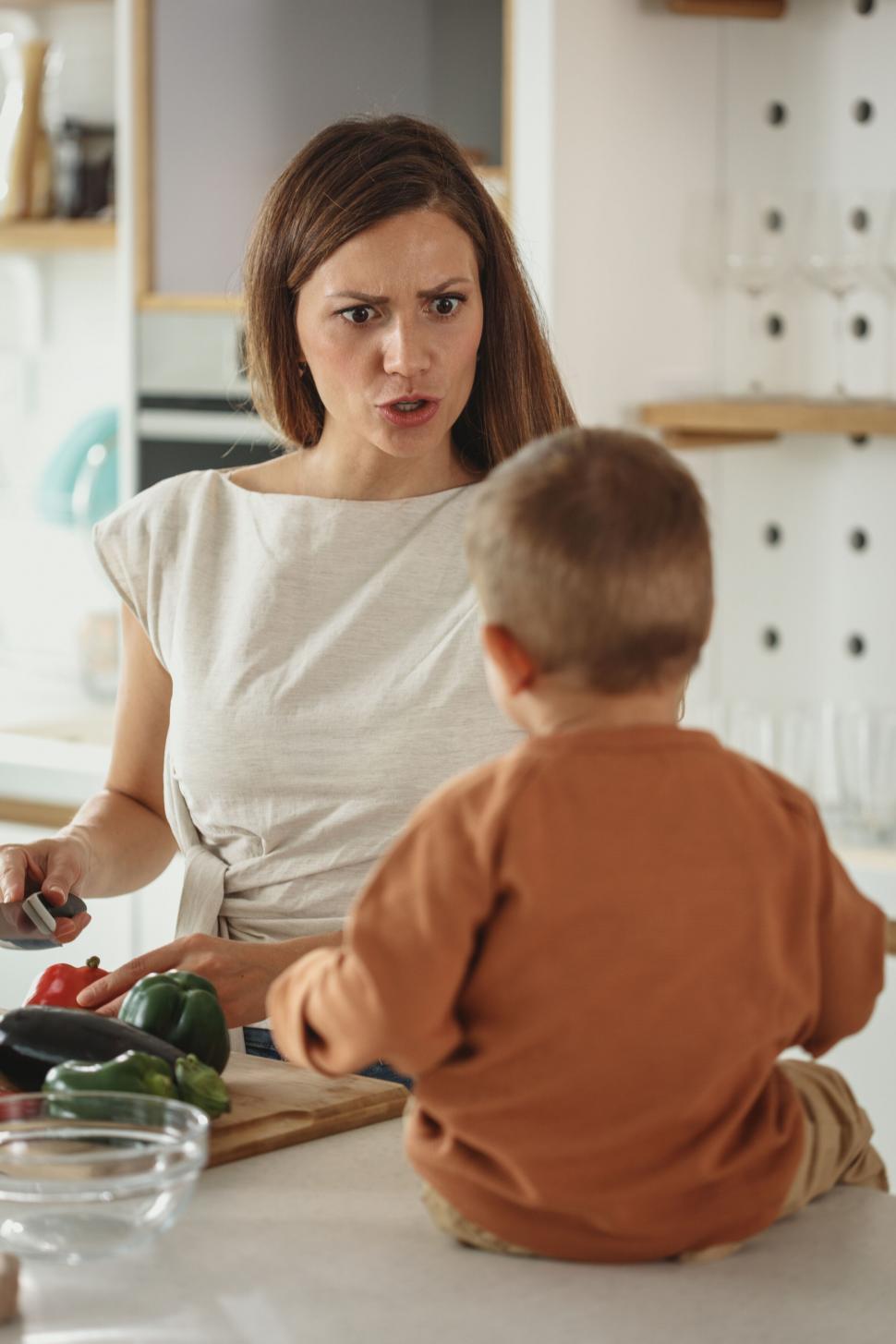Free Image of Mother scolding her small child in kitchen 