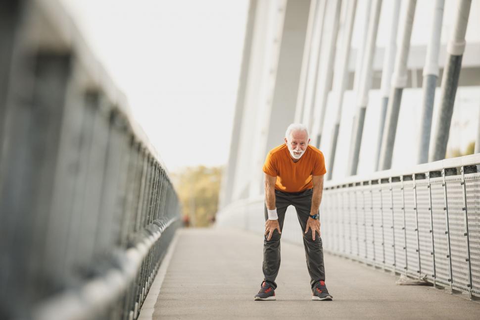 Free Image of Elderly man resting after jogging 