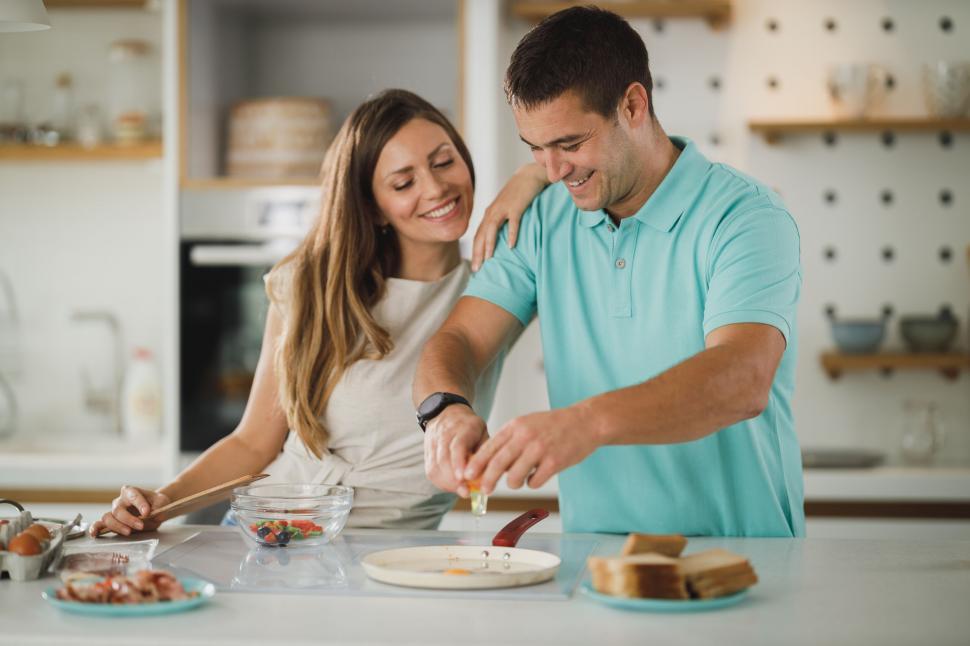 Free Image of Happy couple making breakfast together 