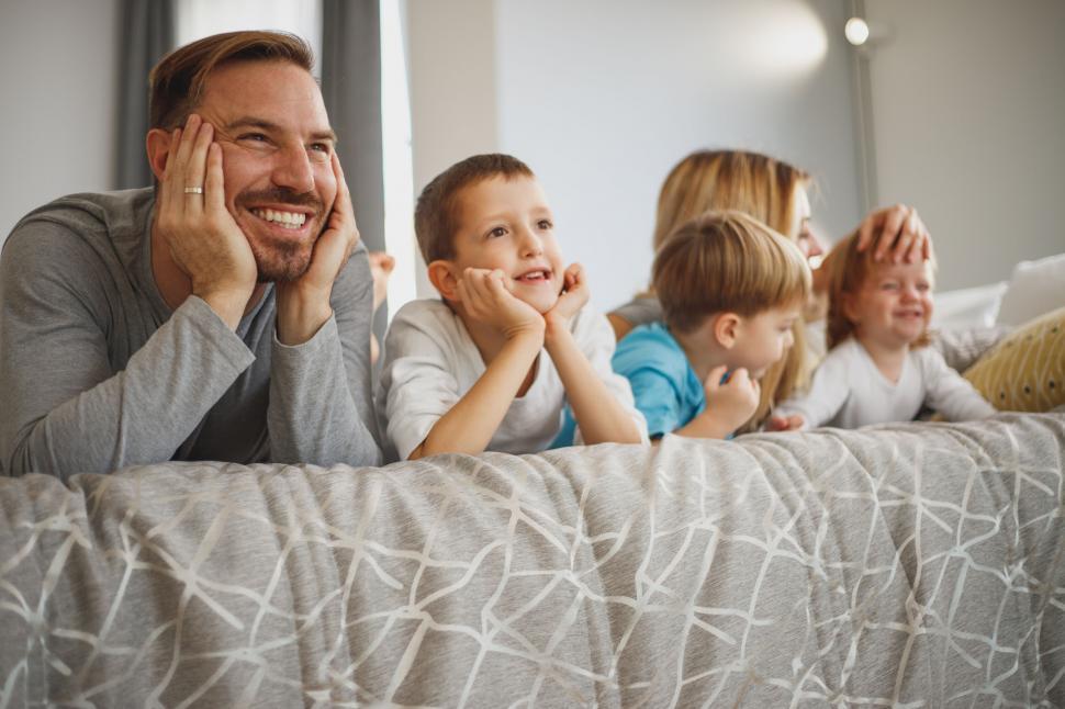 Free Image of Family enjoying time together on bed 
