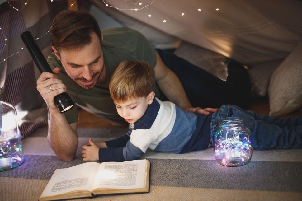 Free Image of Father and son reading under a fort 
