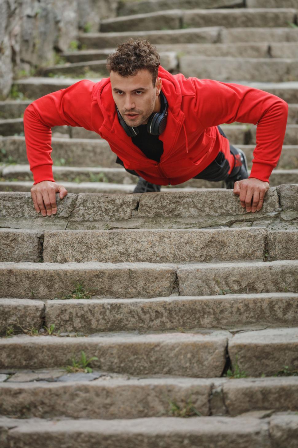 Free Image of Man doing push-ups on outdoor stairs 