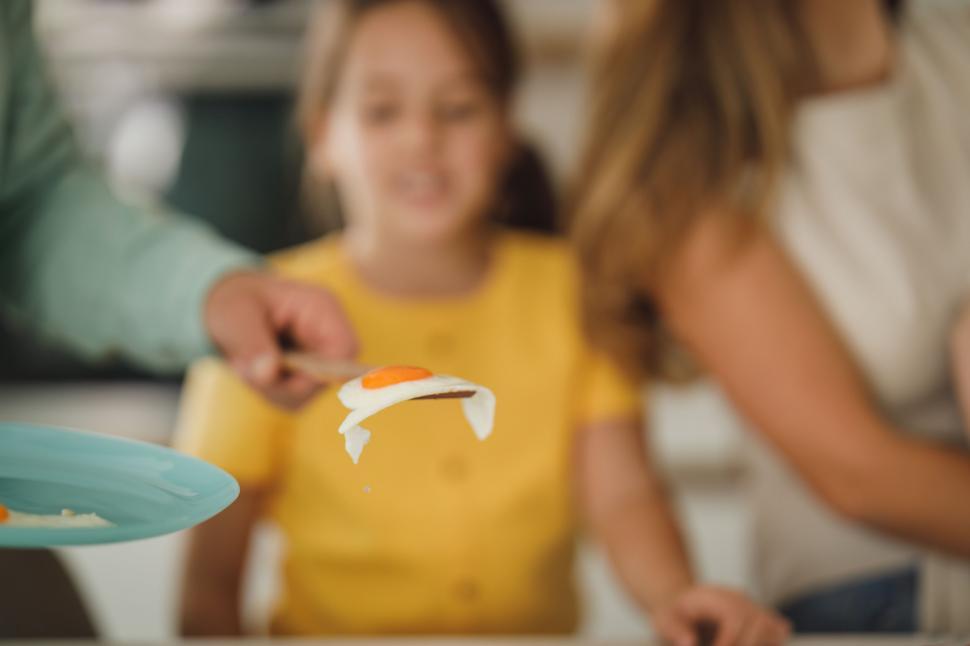 Free Image of Focused on food preparation with blurred child 