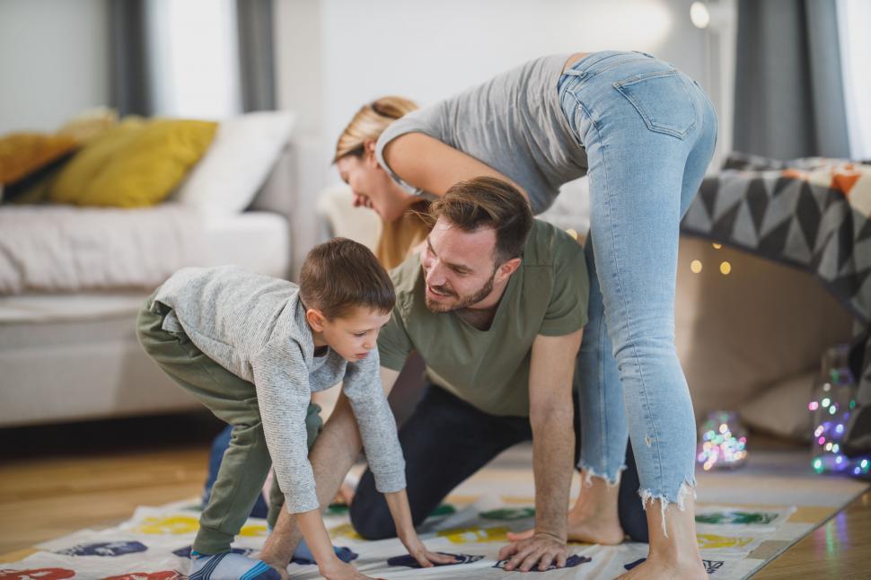 Free Image of Family playing a game on the floor at home 