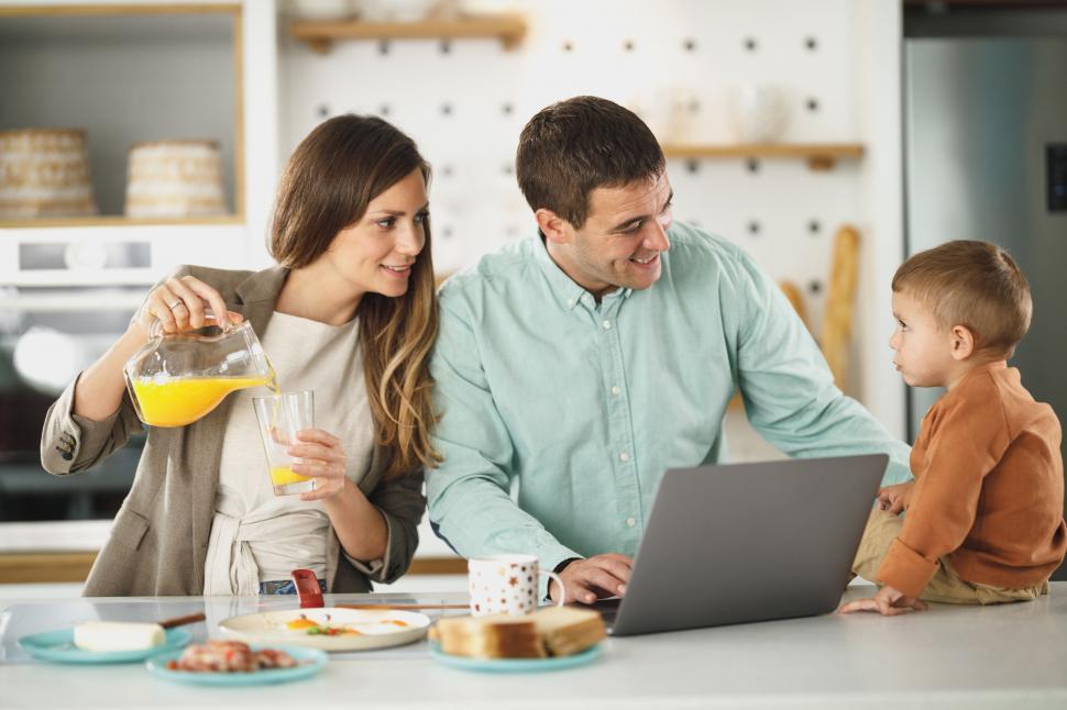 Free Image of Family having breakfast and using a laptop 