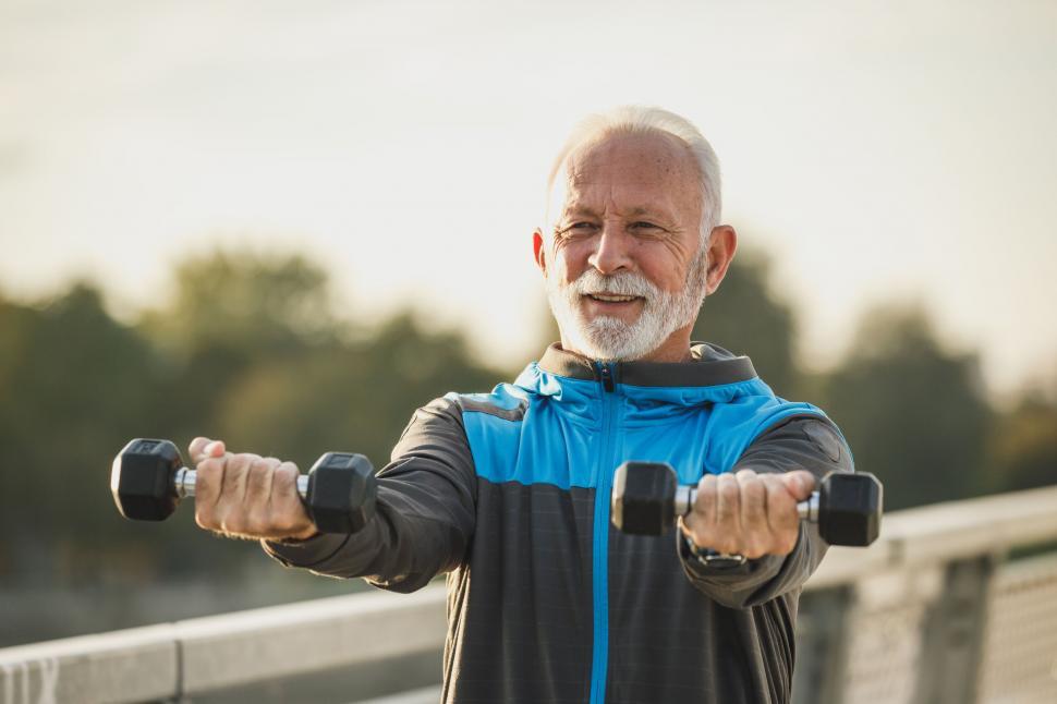 Free Image of Senior man exercising with dumbbells outdoors 