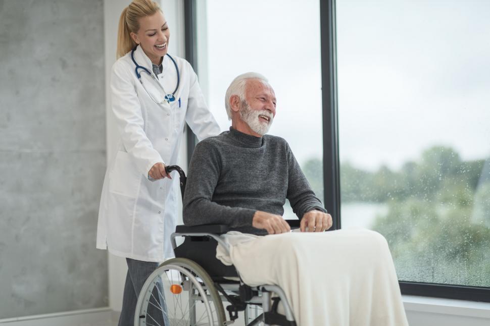 Free Image of Female doctor cheering up senior patient 