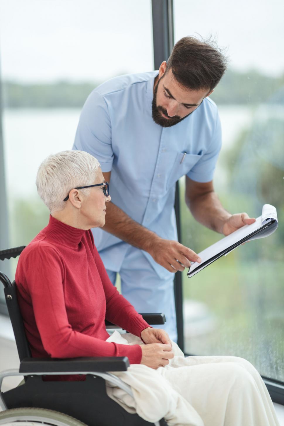Free Image of Senior patient discussing health with male nurse 