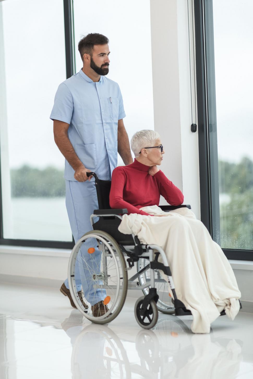 Free Image of Elderly woman in wheelchair with caregiver 