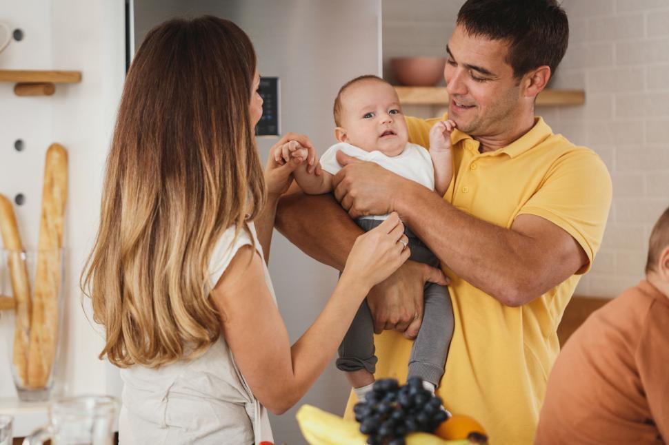 Free Image of Happy family playing with baby 