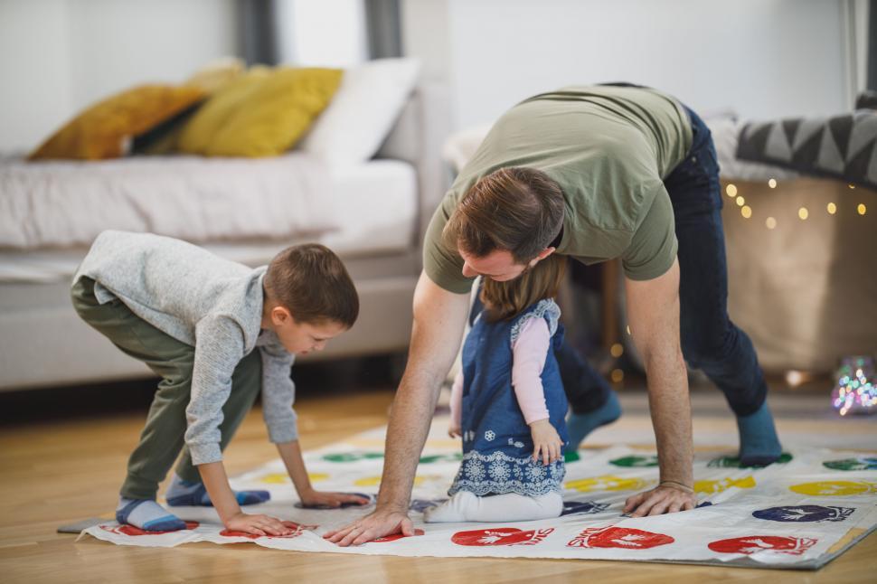 Free Image of Family playing a game of Twister at home 