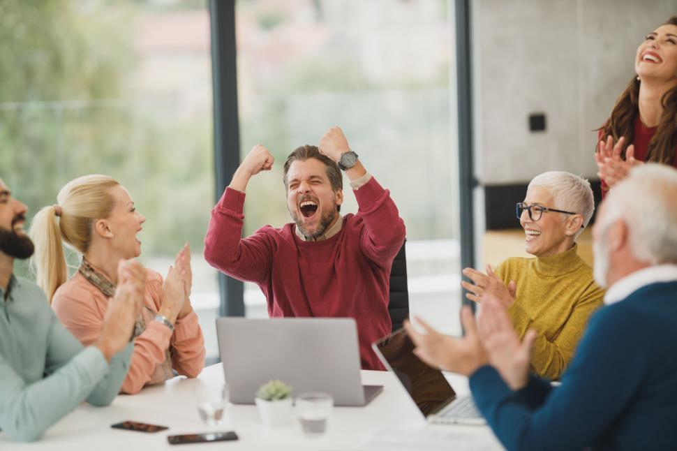 Free Image of Team celebrating success in office meeting 