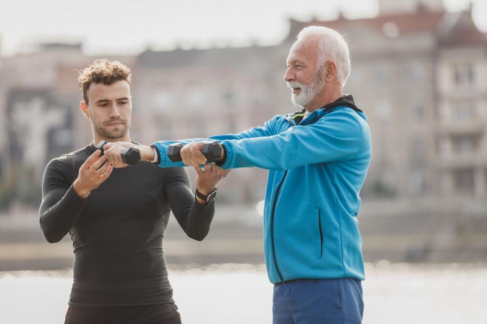 Free Image of Senior trainer coaching young man outdoors 