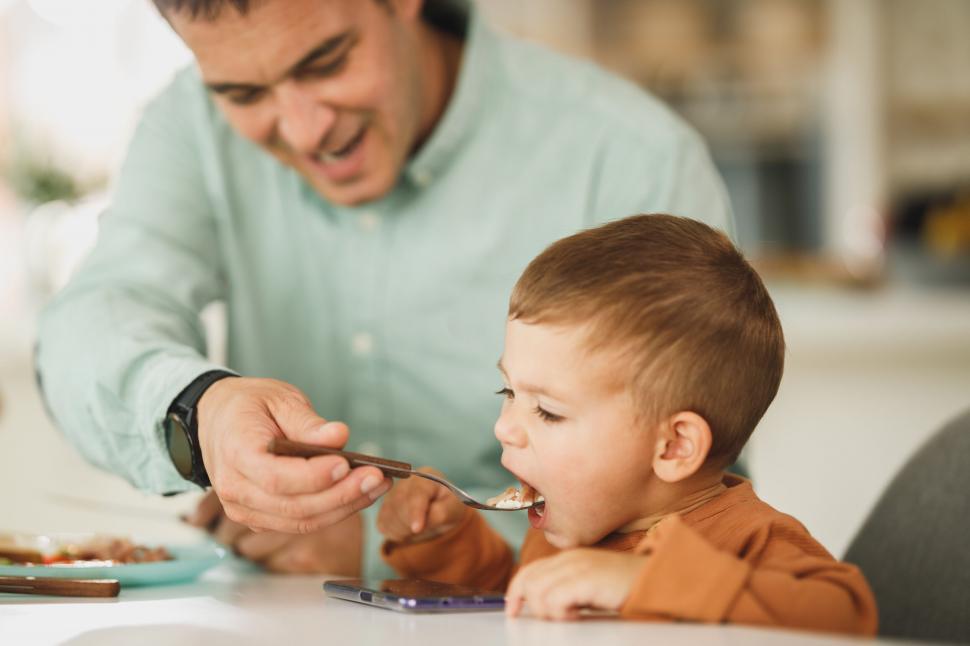 Free Image of Father cutting son s food at mealtime 