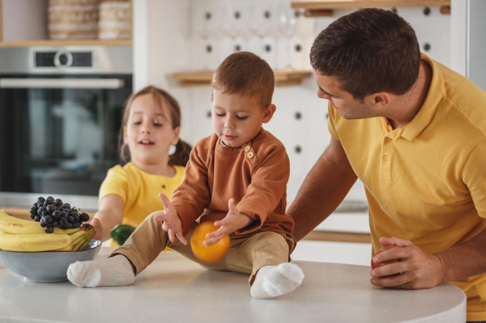 Free Image of Family enjoying time in modern kitchen 