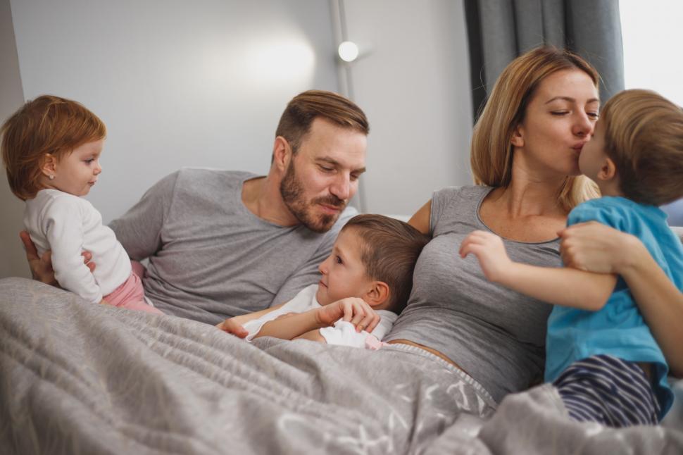 Free Image of Happy family enjoying time together on bed 