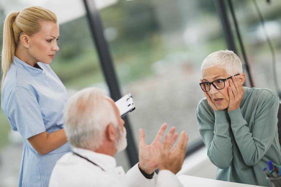 Free Image of Concerned patient talking to healthcare team 