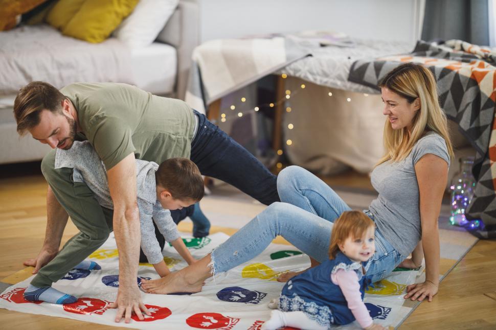 Free Image of Family playing a game on the floor at home 
