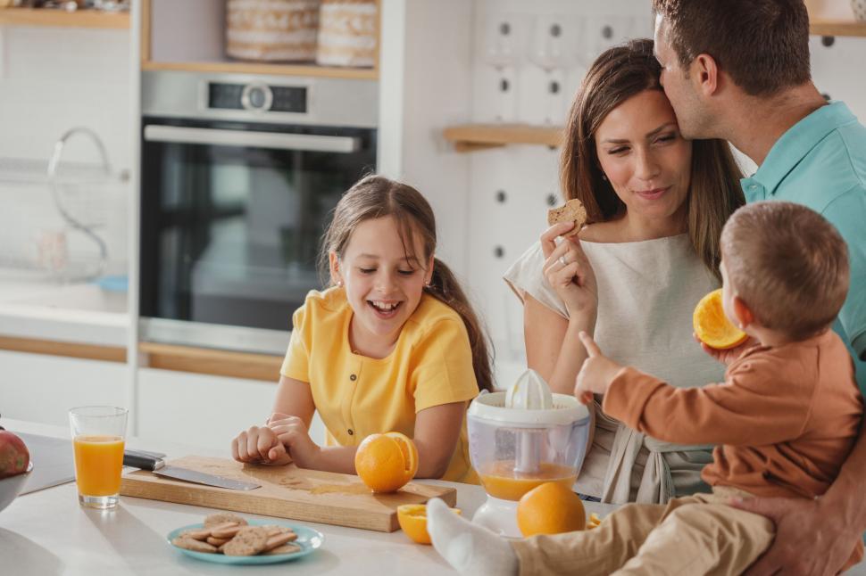 Free Image of Family preparing breakfast together in kitchen 