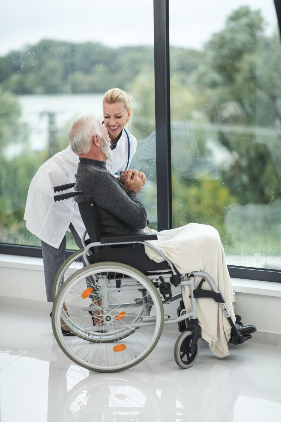 Free Image of Caring nurse with elderly man in wheelchair 