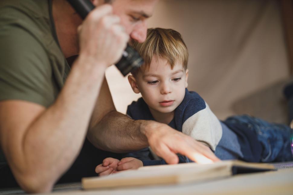 Free Image of Close-up of a father-son reading moment 