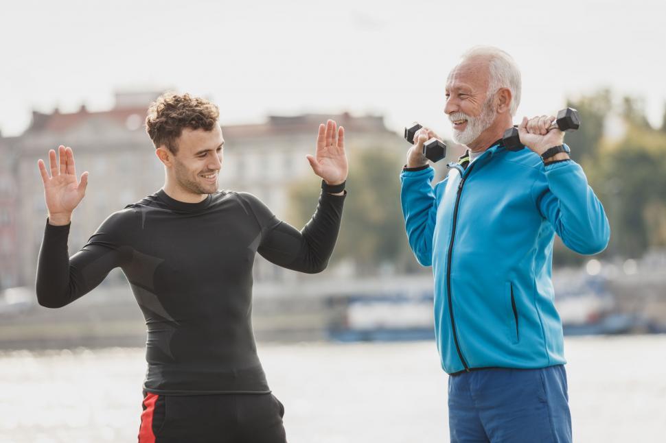 Free Image of Senior man and trainer exercising outdoors 