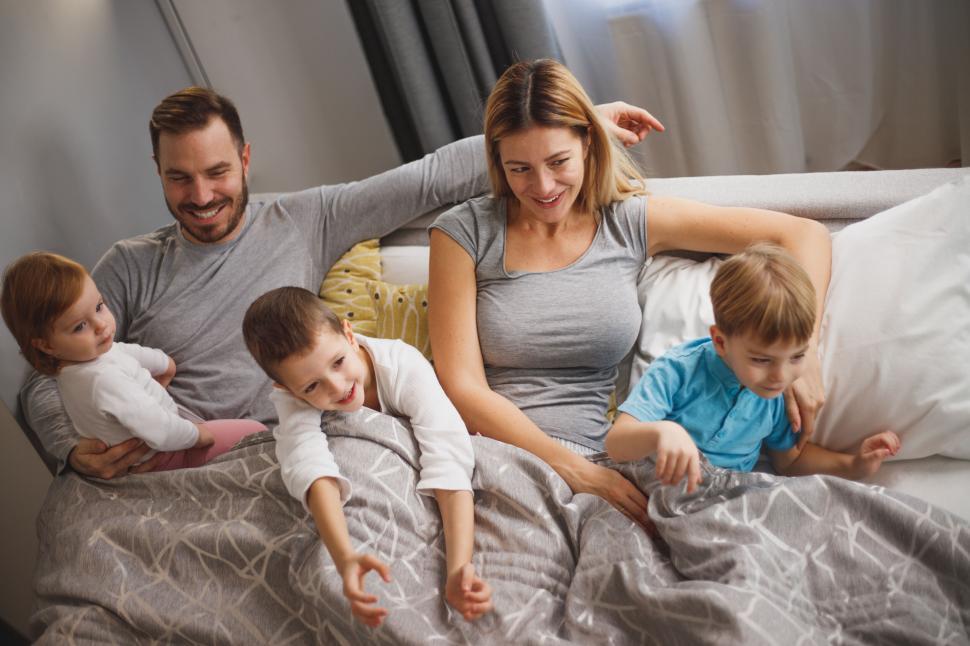 Free Image of Joyful family with children lounging in bed 