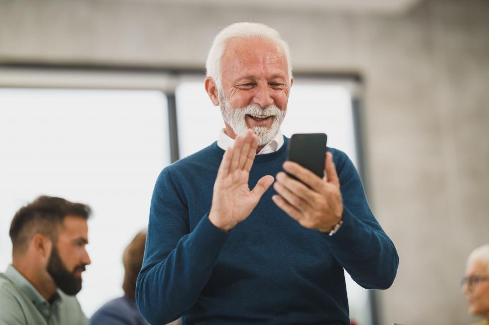 Free Image of Elderly man video chatting on smartphone 