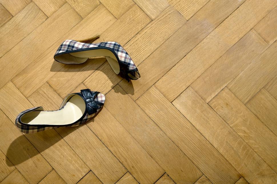Free Image of Single high heel shoe on a wooden floor 